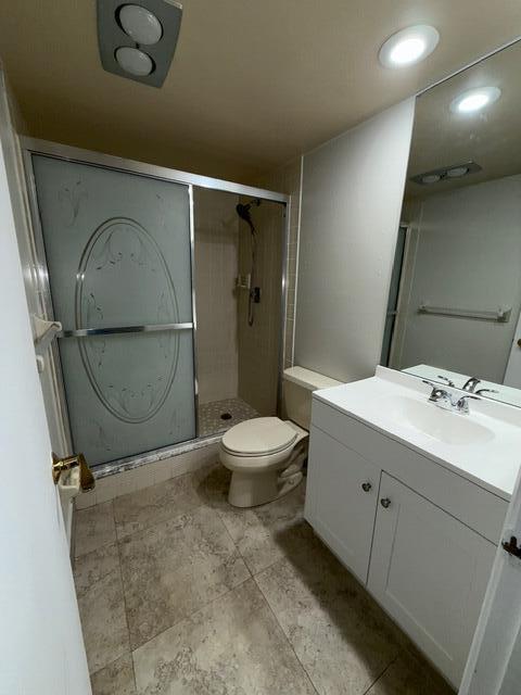 3510 Oaks Way Unit 103, Pompano Beach, FL 33069 - bathroom featuring vanity, a shower stall, and recessed lighting