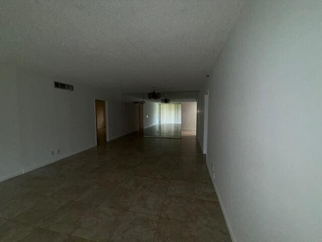 3510 Oaks Way Unit 103, Pompano Beach, FL 33069 - hallway with a textured ceiling