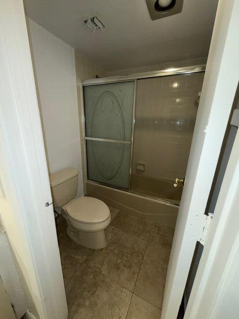 3510 Oaks Way Unit 103, Pompano Beach, FL 33069 - full bathroom with tile patterned floors and enclosed tub / shower combo