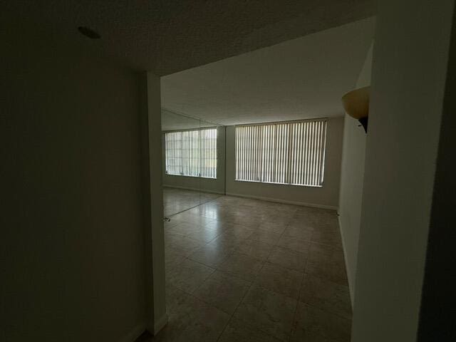 3510 Oaks Way Unit 103, Pompano Beach, FL 33069 - empty room featuring baseboards