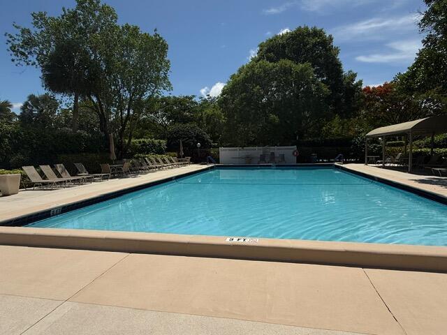 3510 Oaks Way Unit 103, Pompano Beach, FL 33069 - community pool featuring view of scattered trees and a patio