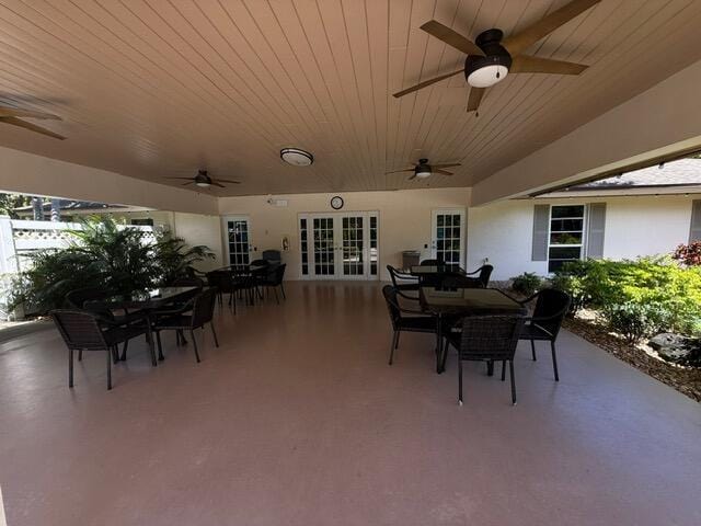 3510 Oaks Way Unit 103, Pompano Beach, FL 33069 - view of patio / terrace featuring outdoor dining area, a ceiling fan, and french doors