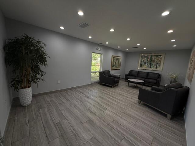3510 Oaks Way Unit 103, Pompano Beach, FL 33069 - living area featuring light wood finished floors and recessed lighting