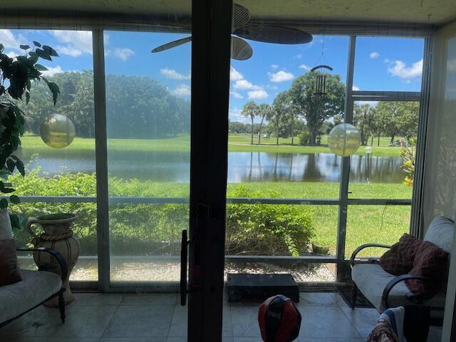 3510 Oaks Way Unit 103, Pompano Beach, FL 33069 - sunroom / solarium with a water view, healthy amount of natural light, and a ceiling fan
