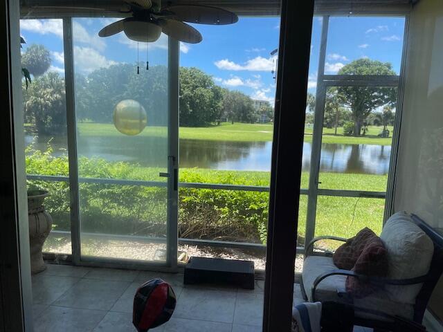 3510 Oaks Way Unit 103, Pompano Beach, FL 33069 - sunroom / solarium featuring a water view, ceiling fan, and healthy amount of natural light
