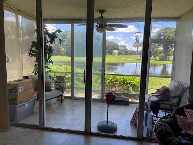 3510 Oaks Way Unit 103, Pompano Beach, FL 33069 - sunroom / solarium with plenty of natural light, a ceiling fan, and a water view