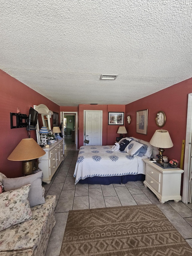 1408 SE 8th Dr, Okeechobee, FL 34974 - tiled bedroom with a textured ceiling