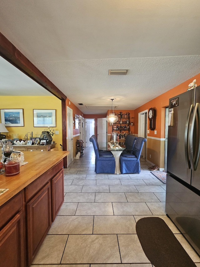 1408 SE 8th Dr, Okeechobee, FL 34974 - dining area with a textured ceiling and light tile patterned floors