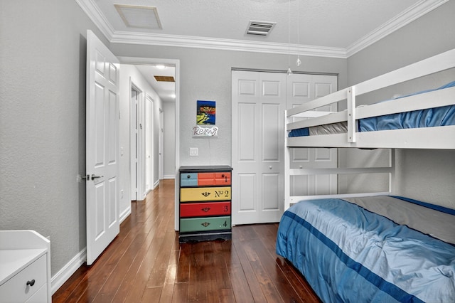 8110 Brigamar Isles Ave, Boynton Beach, FL 33473 - bedroom featuring dark wood-type flooring, ornamental molding, a textured wall, and a closet