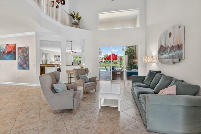 8110 Brigamar Isles Ave, Boynton Beach, FL 33473 - living room with tile patterned flooring, a towering ceiling, and crown molding