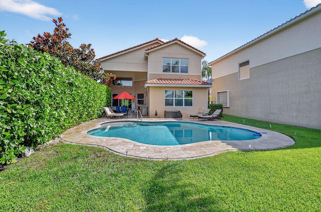 8110 Brigamar Isles Ave, Boynton Beach, FL 33473 - back of property with a tile roof, stucco siding, a lawn, a patio area, and an outdoor pool