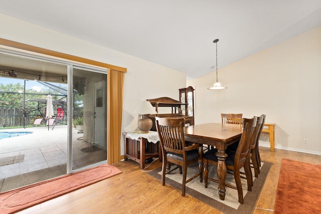 397 SW Jeanne Ave, Port Saint Lucie, FL 34953 - dining room featuring light wood-style floors and vaulted ceiling