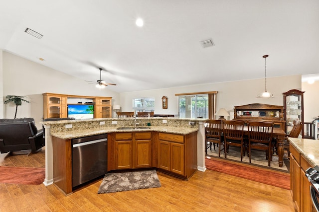 397 SW Jeanne Ave, Port Saint Lucie, FL 34953 - kitchen featuring stainless steel dishwasher, open floor plan, a ceiling fan, brown cabinets, and light wood-style flooring