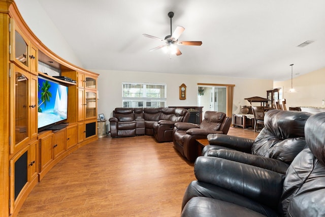397 SW Jeanne Ave, Port Saint Lucie, FL 34953 - living room with light wood-style flooring, vaulted ceiling, and a ceiling fan
