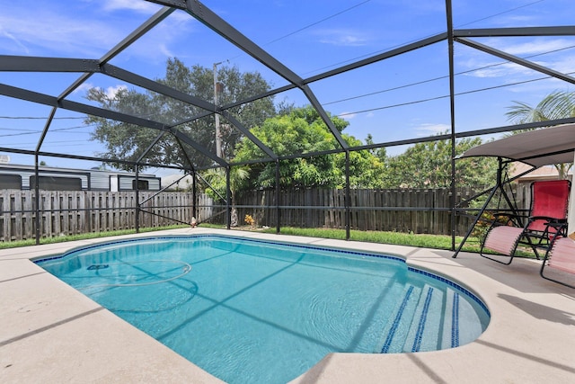 397 SW Jeanne Ave, Port Saint Lucie, FL 34953 - view of swimming pool featuring a fenced backyard, a patio area, and glass enclosure