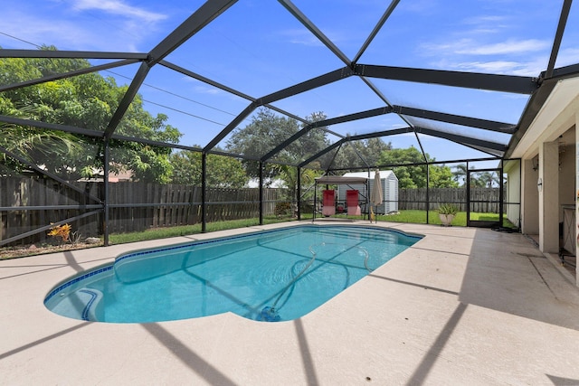 397 SW Jeanne Ave, Port Saint Lucie, FL 34953 - view of swimming pool featuring a storage shed, a fenced backyard, a patio, and glass enclosure