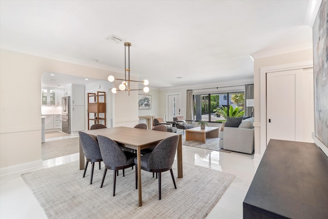 910 SW 21st St, Boca Raton, FL 33486 - dining room with light tile patterned flooring, crown molding, and a chandelier