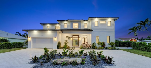 811 Chukker Rd, Delray Beach, FL 33483 - view of front facade with decorative driveway, stucco siding, and an attached garage