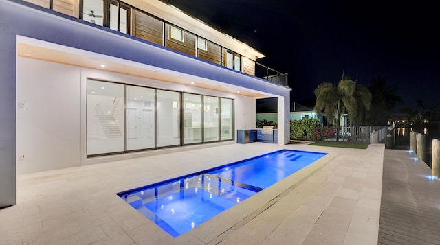 811 Chukker Rd, Delray Beach, FL 33483 - pool at twilight featuring an in-ground hot tub and a patio