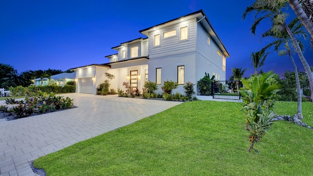 811 Chukker Rd, Delray Beach, FL 33483 - contemporary house featuring driveway, stucco siding, a garage, and a lawn
