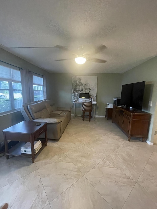 1033 Newport H Unit 1033, Deerfield Beach, FL 33442 - living area featuring a textured ceiling and ceiling fan
