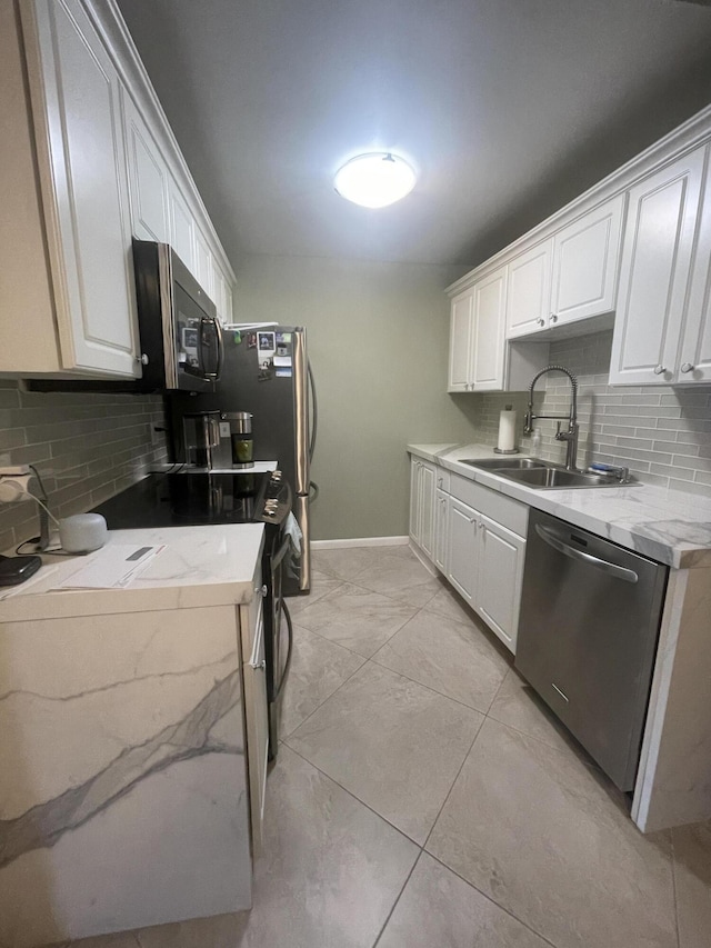 1033 Newport H Unit 1033, Deerfield Beach, FL 33442 - kitchen with stainless steel appliances, backsplash, and white cabinetry