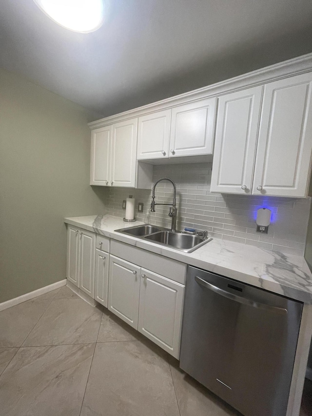 1033 Newport H Unit 1033, Deerfield Beach, FL 33442 - kitchen with stainless steel dishwasher, white cabinetry, decorative backsplash, and light marble finish flooring