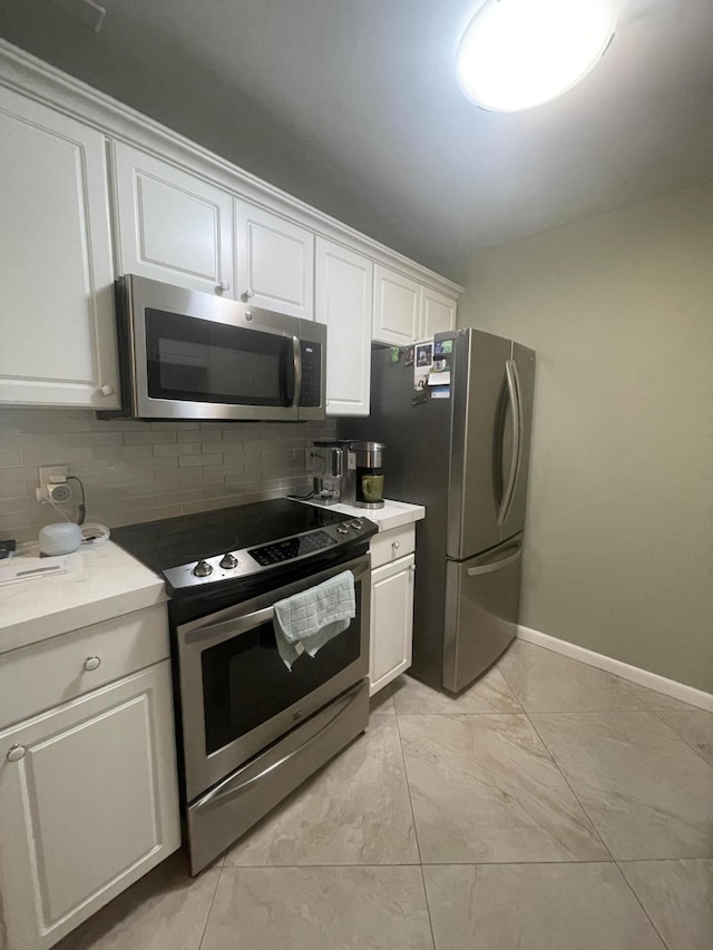 1033 Newport H Unit 1033, Deerfield Beach, FL 33442 - kitchen featuring stainless steel appliances, white cabinetry, and decorative backsplash