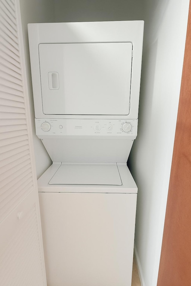 101 SE Ocean Blvd Unit 304, Stuart, FL 34994 - washroom featuring estacked washer and dryer