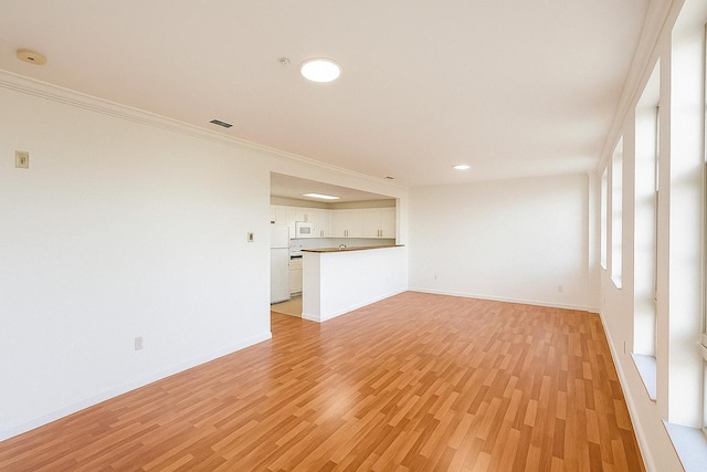 101 SE Ocean Blvd Unit 304, Stuart, FL 34994 - unfurnished living room with light wood-type flooring, crown molding, and recessed lighting