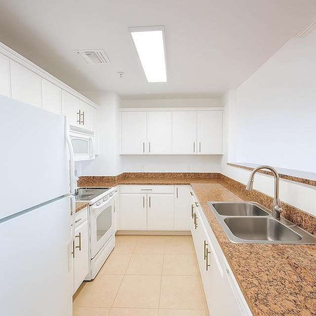 101 SE Ocean Blvd Unit 304, Stuart, FL 34994 - kitchen featuring white appliances, light tile patterned floors, and white cabinets