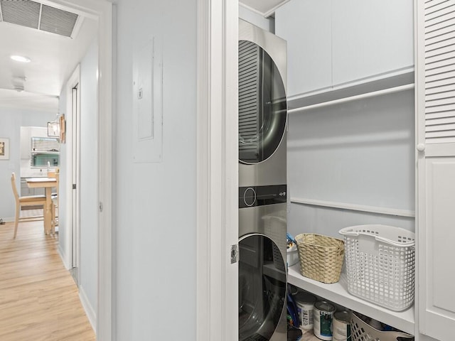 1706 Lakefront Blvd Unit D, Fort Pierce, FL 34982 - laundry room featuring estacked washer and dryer and wood finished floors