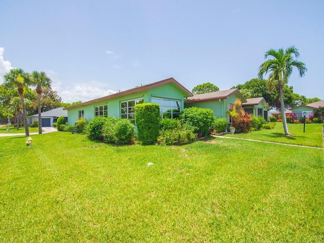 1706 Lakefront Blvd Unit D, Fort Pierce, FL 34982 - view of front of home featuring a front yard, stucco siding, and a garage