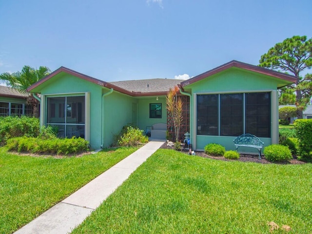 1706 Lakefront Blvd Unit D, Fort Pierce, FL 34982 - single story home featuring a sunroom, a front lawn, and stucco siding