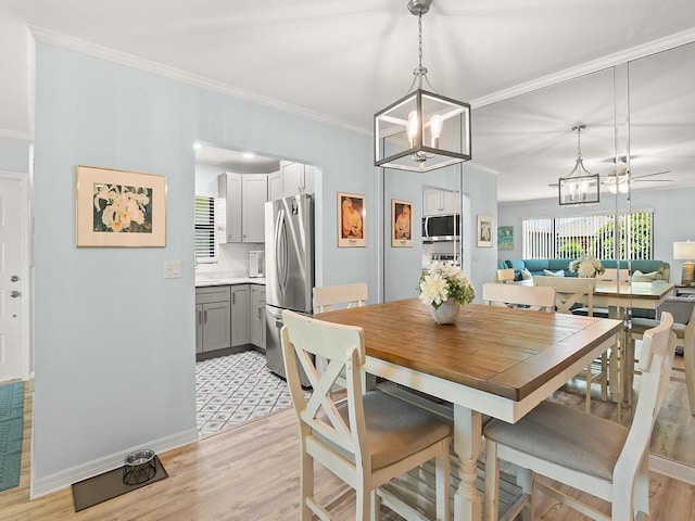 1706 Lakefront Blvd Unit D, Fort Pierce, FL 34982 - dining room with a chandelier, light wood-type flooring, and ornamental molding