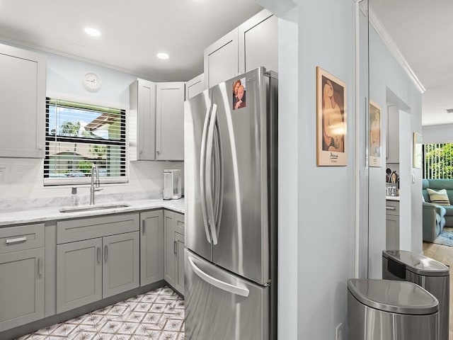1706 Lakefront Blvd Unit D, Fort Pierce, FL 34982 - kitchen featuring freestanding refrigerator, gray cabinetry, decorative backsplash, light flooring, and recessed lighting
