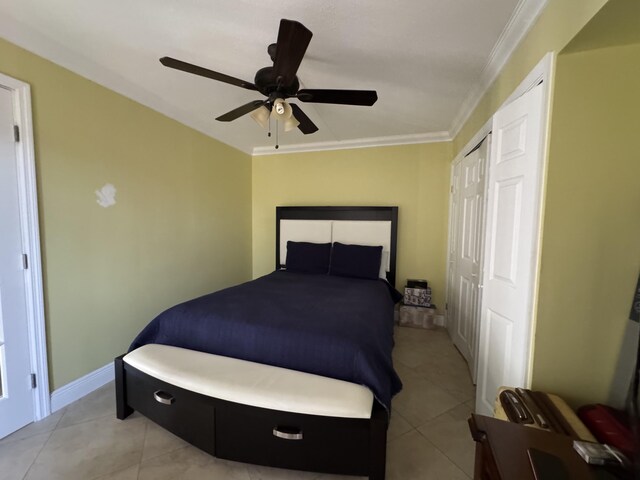 674 Springdale Cir, Palm Springs, FL 33461 - bedroom with light tile patterned flooring, ornamental molding, a ceiling fan, and a closet