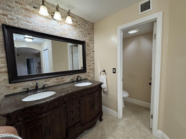 674 Springdale Cir, Palm Springs, FL 33461 - full bath with double vanity, a textured ceiling, and tile patterned flooring