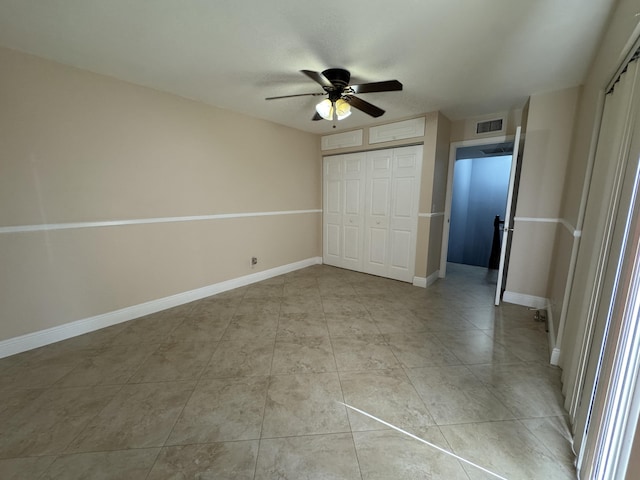 674 Springdale Cir, Palm Springs, FL 33461 - unfurnished bedroom featuring a closet, light tile patterned floors, and a ceiling fan
