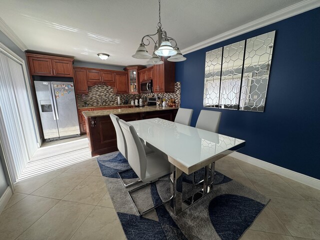674 Springdale Cir, Palm Springs, FL 33461 - dining room with light tile patterned floors, ornamental molding, and a chandelier