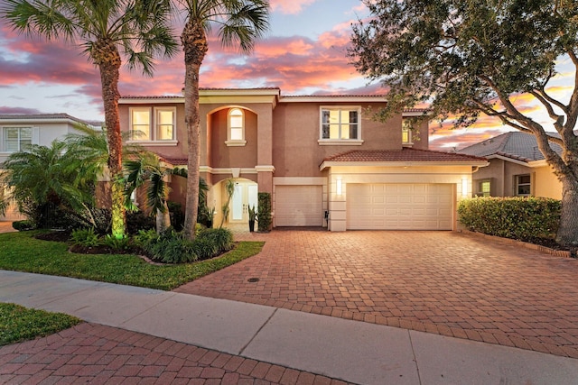 191 Sedona Way, Palm Beach Gardens, FL 33418 - mediterranean / spanish home with decorative driveway, stucco siding, a tile roof, and a garage