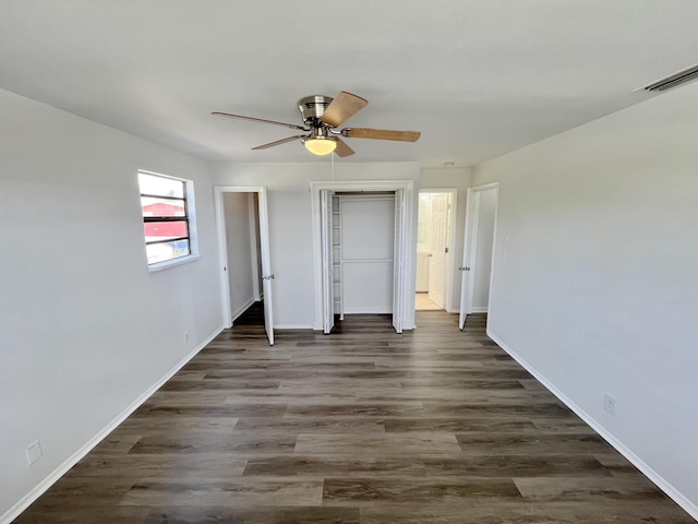 5163 Marion Pl, West Palm Beach, FL 33407 - unfurnished bedroom featuring dark wood-style floors, ceiling fan, and a closet