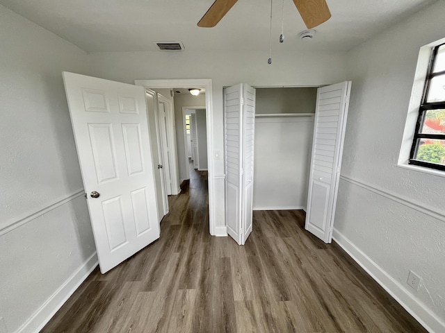 5163 Marion Pl, West Palm Beach, FL 33407 - unfurnished bedroom with wood finished floors, a closet, and a ceiling fan