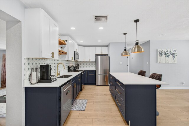 826 Cochran Dr, Lake Worth Beach, FL 33461 - kitchen with stainless steel appliances, white cabinets, light countertops, open shelves, and recessed lighting