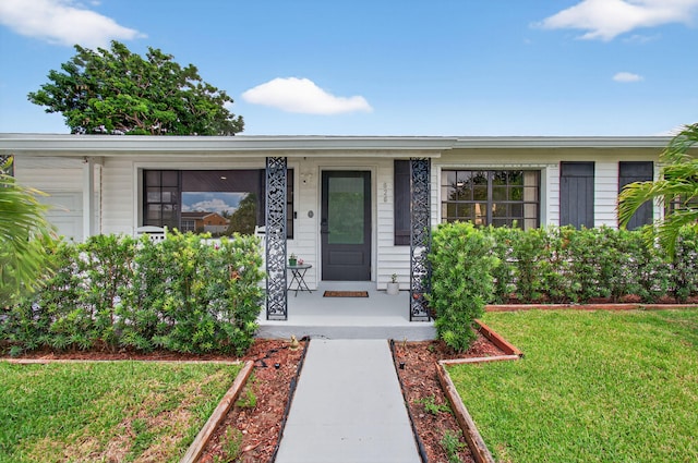 826 Cochran Dr, Lake Worth Beach, FL 33461 - view of front of house with covered porch and a front yard