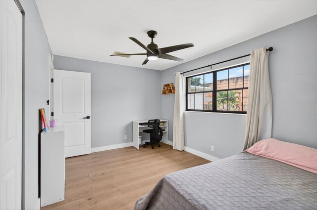 826 Cochran Dr, Lake Worth Beach, FL 33461 - bedroom with light wood-style floors, a desk, and ceiling fan