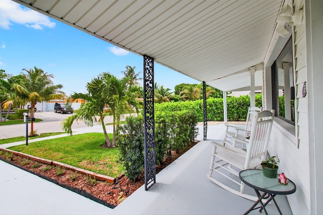 826 Cochran Dr, Lake Worth Beach, FL 33461 - covered porch featuring a lawn