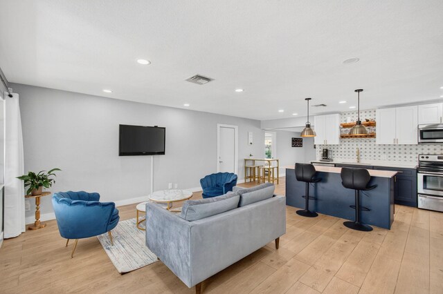 826 Cochran Dr, Lake Worth Beach, FL 33461 - living room featuring light wood-type flooring and recessed lighting