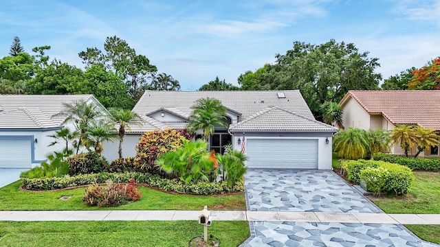 8291 Lake Cypress Rd, Lake Worth, FL 33467 - single story home with a garage, a tiled roof, stucco siding, a front yard, and driveway