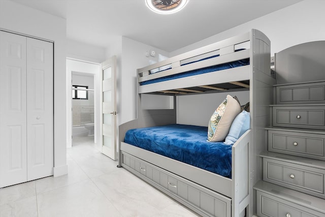 2800 NE 48th St, Lighthouse Point, FL 33064 - bedroom with light tile patterned flooring and ensuite bath
